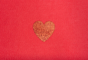 Glitter heart on red background 