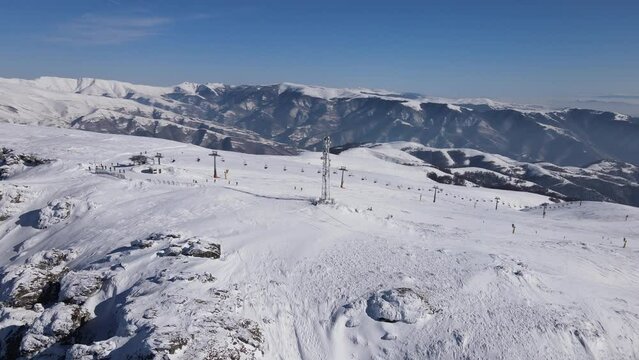 Stara Planina babin Zub Ski track with Gondola type cable car transport Skiers on snow covered slope of ski resort Landscape with snowy piste Aerial drone view old mountain Balkan