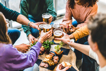 Group of friends cheering beer glasses at brewery pub patio, Happy young people toasting and having fun enjoying at restaurant bar sitting at table-Beverage Life Style concept with guys and girl - obrazy, fototapety, plakaty