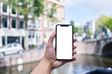 Man holding smartphone showing white blank screen at amsterdam