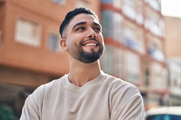 Young arab man smiling confident standing at street