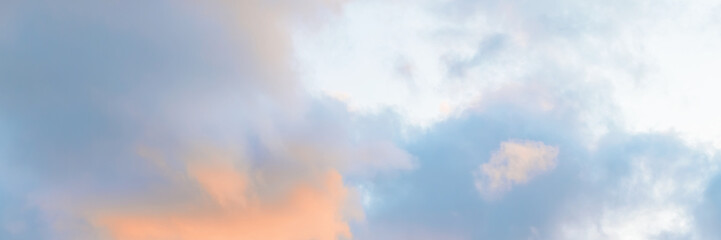 Beautiful sunset sky. Clouds illuminated by red sunlight at sunset. This view of the sky with clouds at sunset. Wide panoramic background for design.