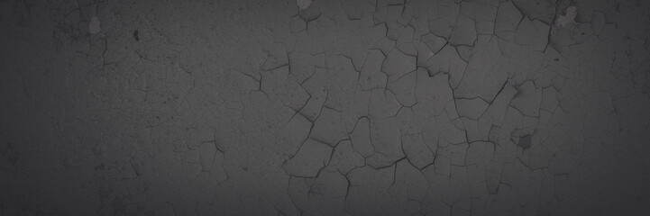 Dark wide panoramic background. Peeling paint on a concrete wall. Faded dark texture of old cracked flaking paint. Weathered rough painted surface with patterns of cracks. Shaded background for design
