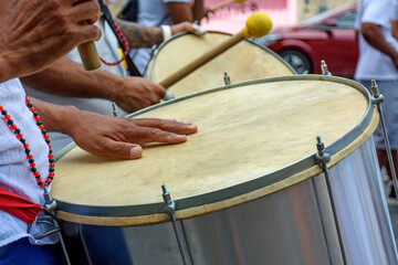 Obraz na płótnie Canvas Drummer playing his instrument during carnival celebrations in the streets of Brazil