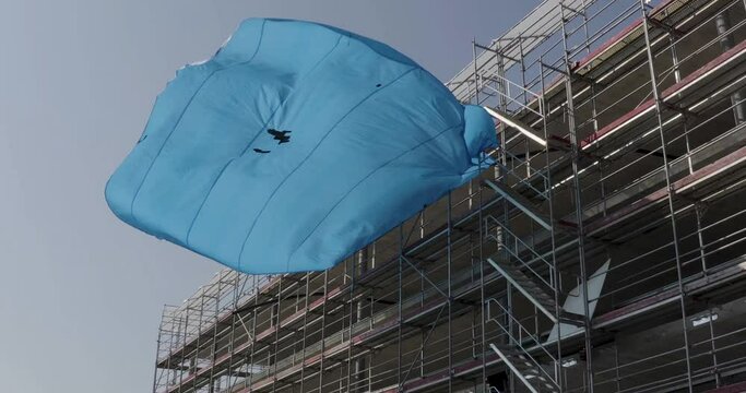 Beautiful construction tarpaulin slowly dancing in the wind
