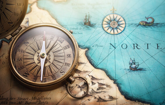 Magnetic old compass on world map.Travel, geography, navigation, tourism and exploration concept background. Treasure Island on the Pirate Map.