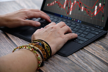 Efficient Work, Close-up of Woman's Hands Typing on a Keyboard and Viewing Graphs on a Wooden Desk