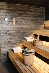 Modern interior of wooden spa cabin. View of empty Finnish sauna room with dry steam. New and fresh