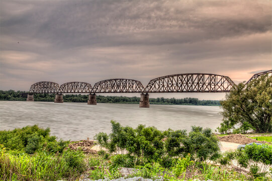 View of the Metropolis BNSF railroad bridge over the Ohio River.  Dramatic clouds over the river. 