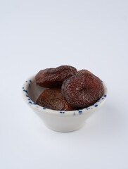 Dark Dried Apricots On A Plate.