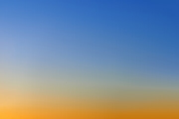 Fototapeta premium Sunset on the clear sky with blue, orange and red colors. Color gradient of the morning sky. Beautiful bright sunrise on the sky, background.