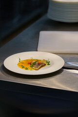 Sea bass appetizer on a white plate