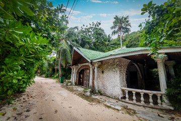 Old house in a dirt road of a tropical island
