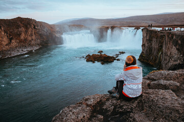 Woman Traveller at Godafoss waterfall in Iceland.