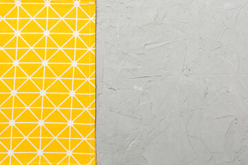 top view with yellow empty kitchen napkin isolated on table background. Folded cloth for mockup...