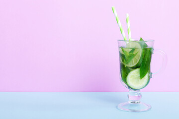 Mojito summer refreshing cocktail with ice and mint. mojito cocktail with lime, lemon and mint in a tall glass with a stick - obrazy, fototapety, plakaty