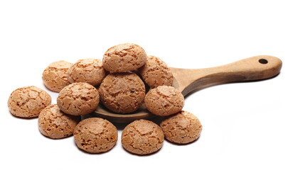 Sweet cookies with apricots in wooden spoon isolated on white, side view