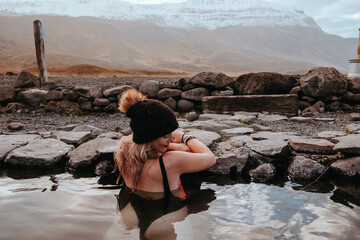 Woman enjoying sunset at Hoffel Hot Tubs, Iceland