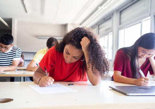 Group of teenager students do an exam in a classroom. Education, high school