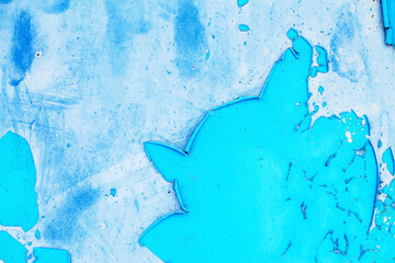 Old blue paint peeling from metal or concrete wall texture background.