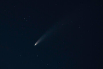 A "falling star" (NEOWISE comet) in black clear skies