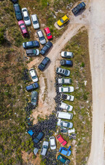 A topdown aerial view of a car cemetery