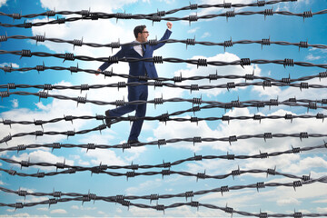 Businessman in barbed wire concept