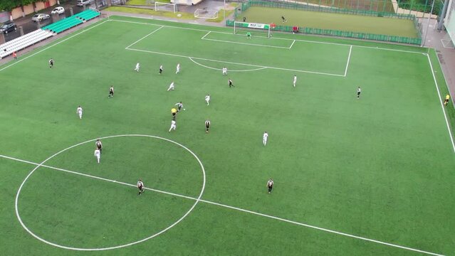 Top view football field, amateur adult teams playing