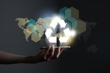 Hand holding recycle symbol on a screen of mobile phone. Mobile applications as asource of...
