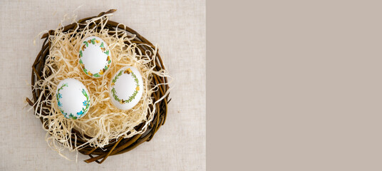 banner a lot of space for text coffee background Easter eggs decorated with painted embroidery ribbons on eggshell in nest three white eggs on shavings advertising invitation postcard bigboard