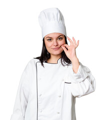 Young caucasian cook woman isolated with fingers on lips keeping a secret.