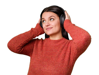 A woman listens to music through headphones, feeling and enjoying the sound. She is relaxed and...