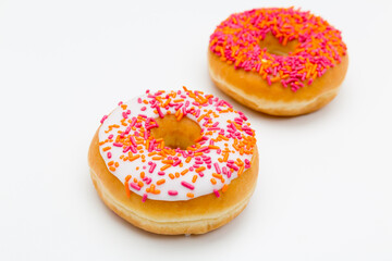 two orange and white colorful tasty donuts isolated