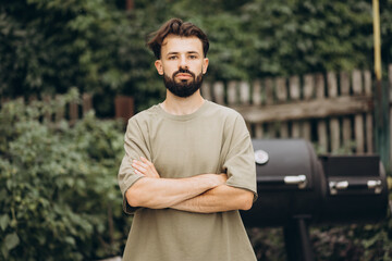 bbq guy, a man on the background of the grill who can be a cook or just a fan of cooking food on fire