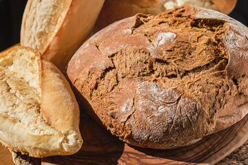 Farm bakery products, artisan rye and wheat bread, traditional pastries in Turkey. Natural lighting, fresh bread on the table, close-up, selective focus. Homemade whole grain bread