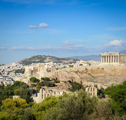 View of the Acropolis, Propylaea, Parthenon in the distance against the background a blue sky