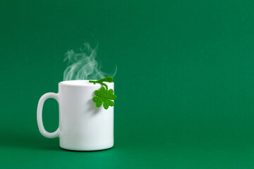 Saint Patricks Day background. White cup of hot tea or coffee with steam for St. Patrick's day,...