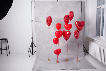 studio photo  zone with red heart-shaped balloons for valentine's day. Gray background. White background