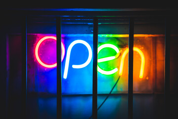 rainbow neon sign saying open - Powered by Adobe