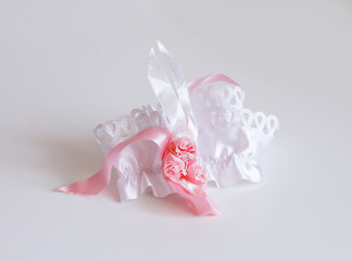 The bride's garter on a pink background.