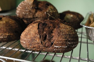 bread on the tablecloth. Home baked whole grain bread. Crusty sourdough loaf of wheat bread with wholegrain flour. fried bread crust.	