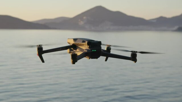 Montenegro, january 2023: drone dji mavic 3 fly, hover over the sea at sunset. back side of drone