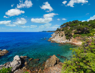 Summer sea rocky coast view with trees and beach (Catalonia, Costa Brava, Spain).