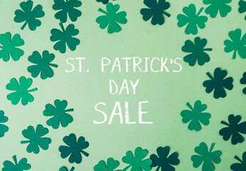 St.Patrick's day sale with a background of clover leaves