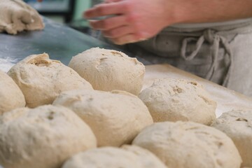 baker at work. The baker shapes the bread. Hands on the close-up form bread