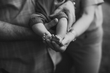 black and white grandparents holding baby