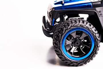 Close-up of a wheel with an off-road tread on a white background. Space for text.