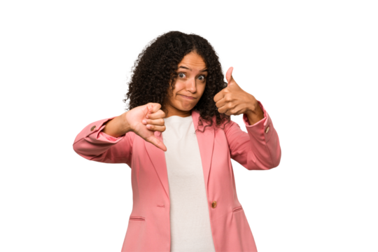 Young african american curly woman isolated showing thumbs up and thumbs down, difficult choose concept