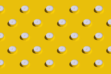Rows of the light candles on a bright yellow background