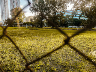 Buenos Aires, Argentina - December 21, 2022: A soccer pitch seen through a chain link fence in...